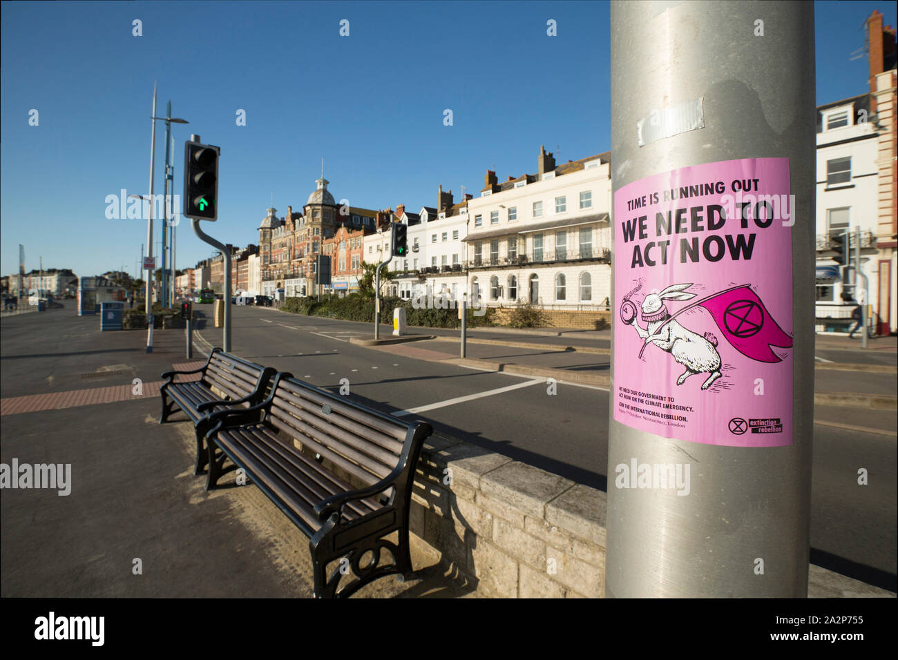 An Extinction Rebellion poster, or flyer, on a lamp post on Weymouth seafront. The poster calls for the Government to address climate change and adver Stock Photo