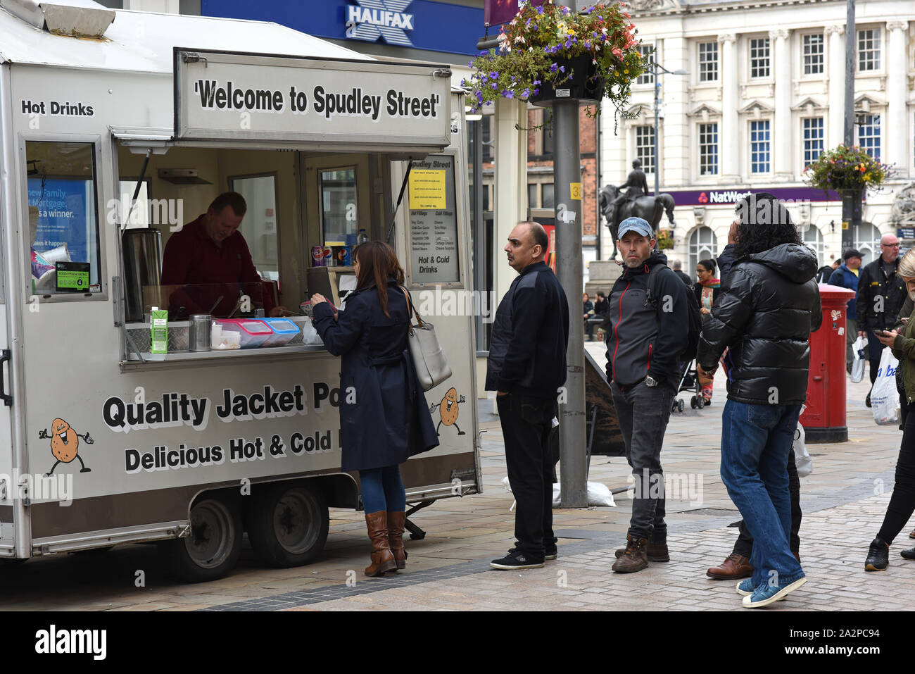 Takeaway food customers queueing for baked potatoes Street photography Wolverhampton, England, Uk. Picture by Dave Bagnall Stock Photo