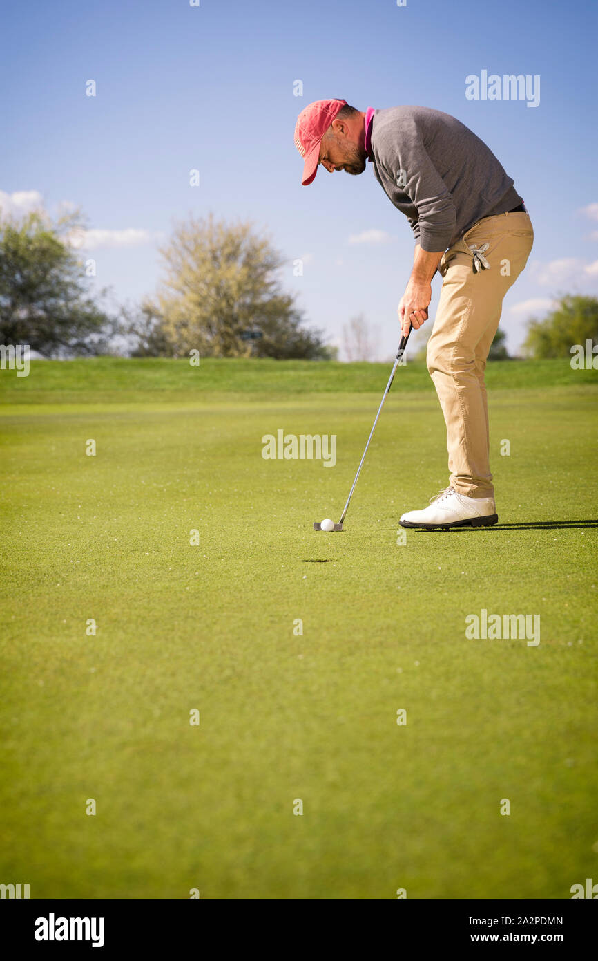 Male golfer putting on green Stock Photo Alamy