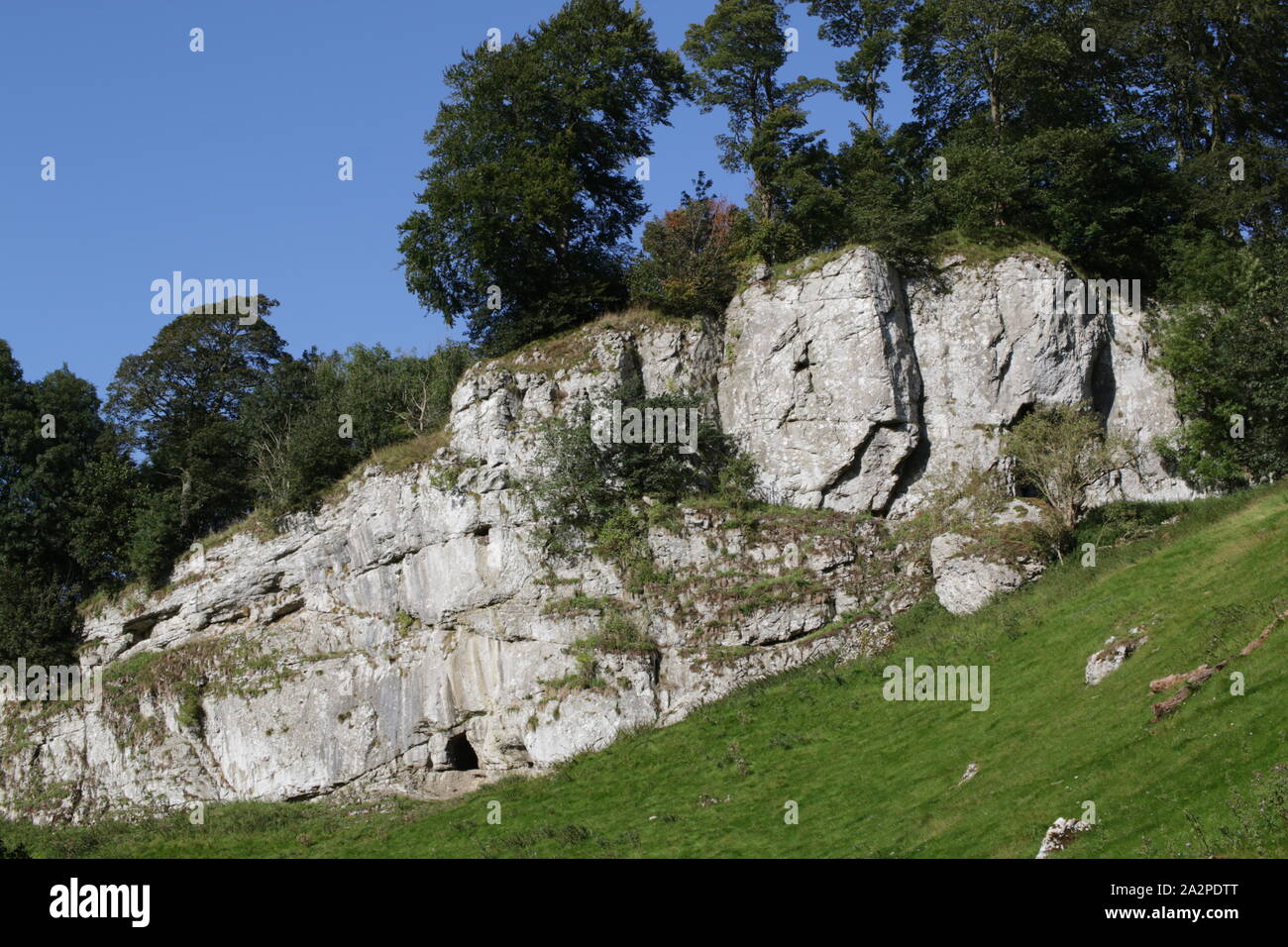 Frank i' th' Rocks cave beside the River Dove in Wolfscote Dale, Derbyshire Stock Photo