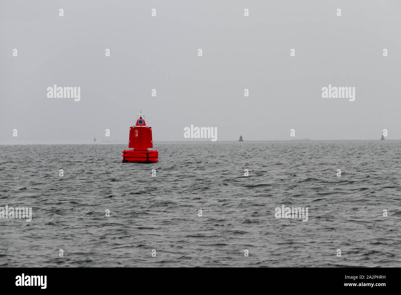 Red marine buoy in a grey sea Stock Photo