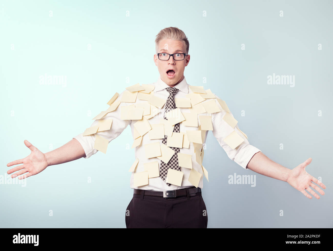Shocked businessman covered by blank post-it notes. Stock Photo
