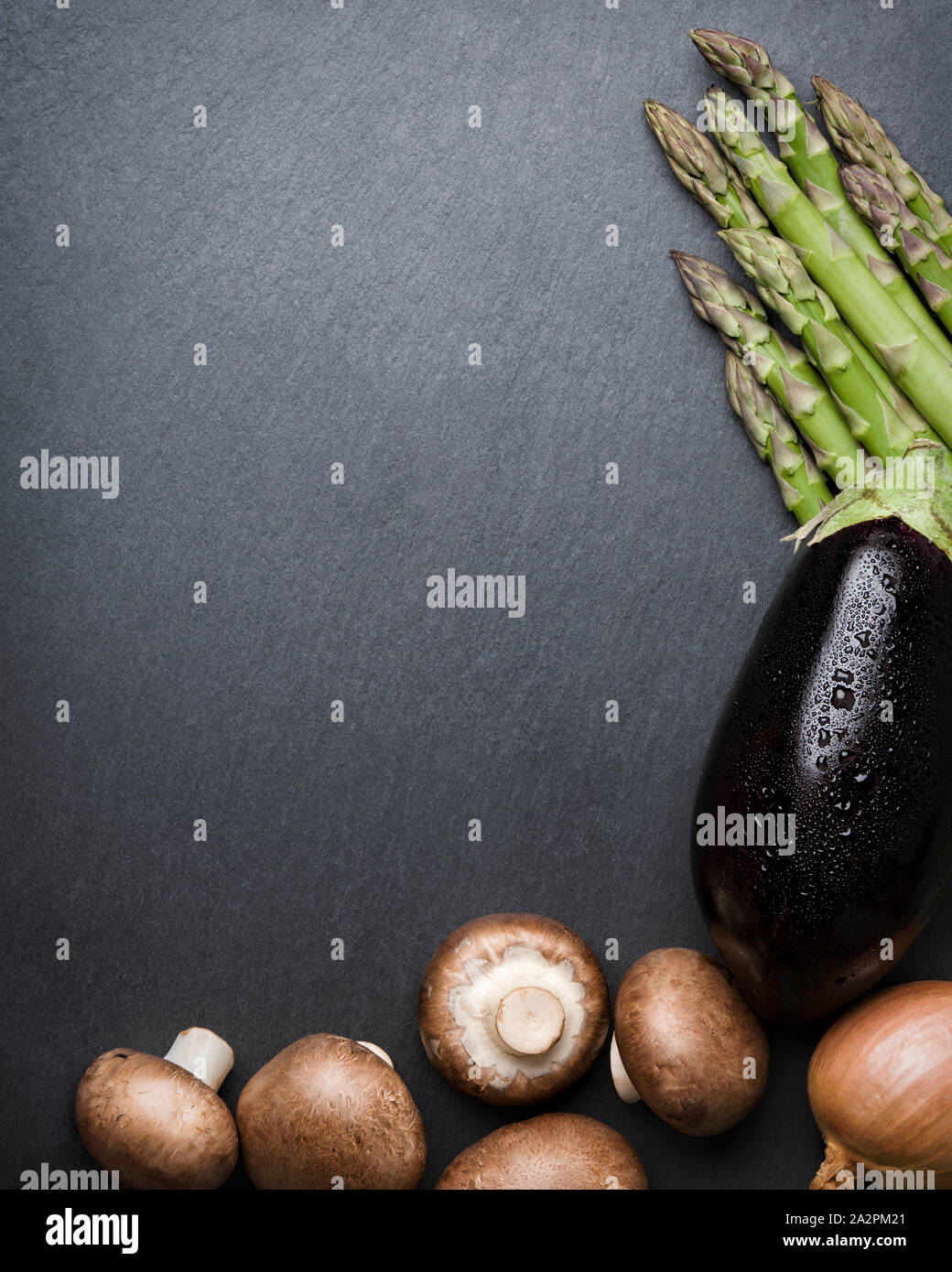 Arrangement of mixed vegetables on dark stone copyspace. Stock Photo