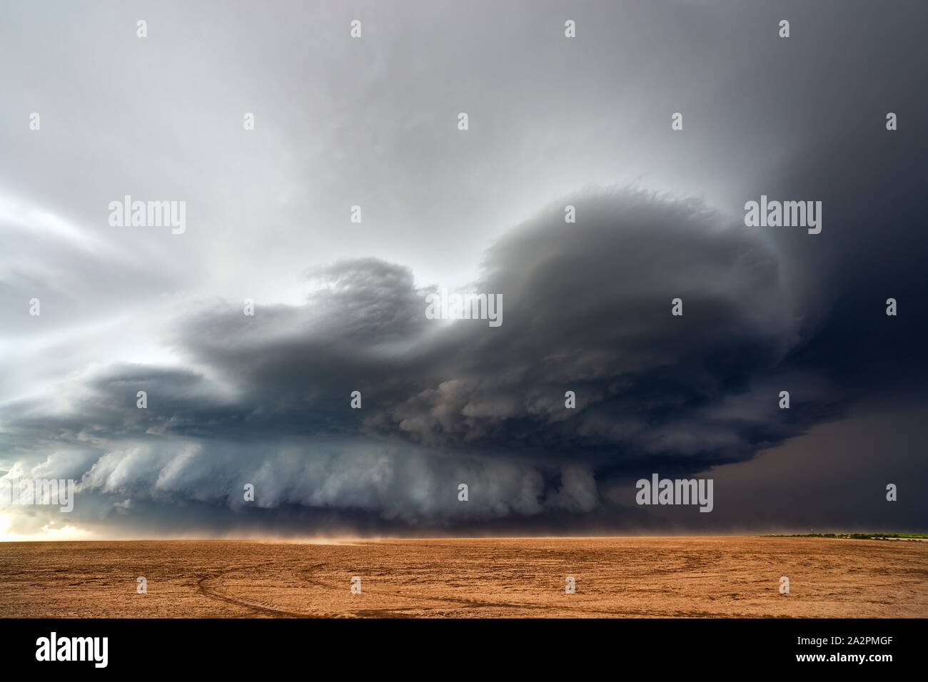 Supercell storm with dramatic clouds over a dusty field near Bethune
