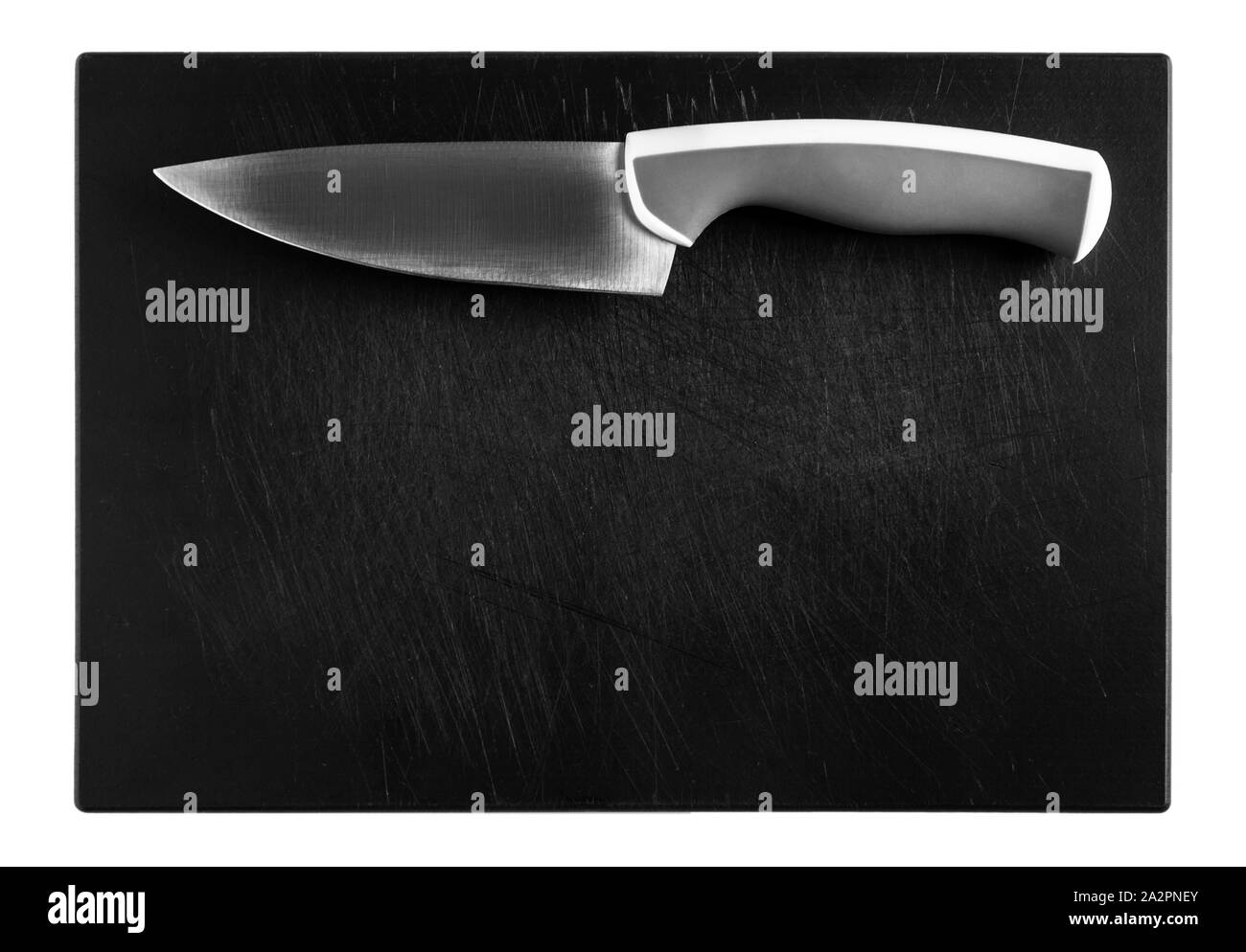 knife on black chopping board, top view of the object on white background Stock Photo