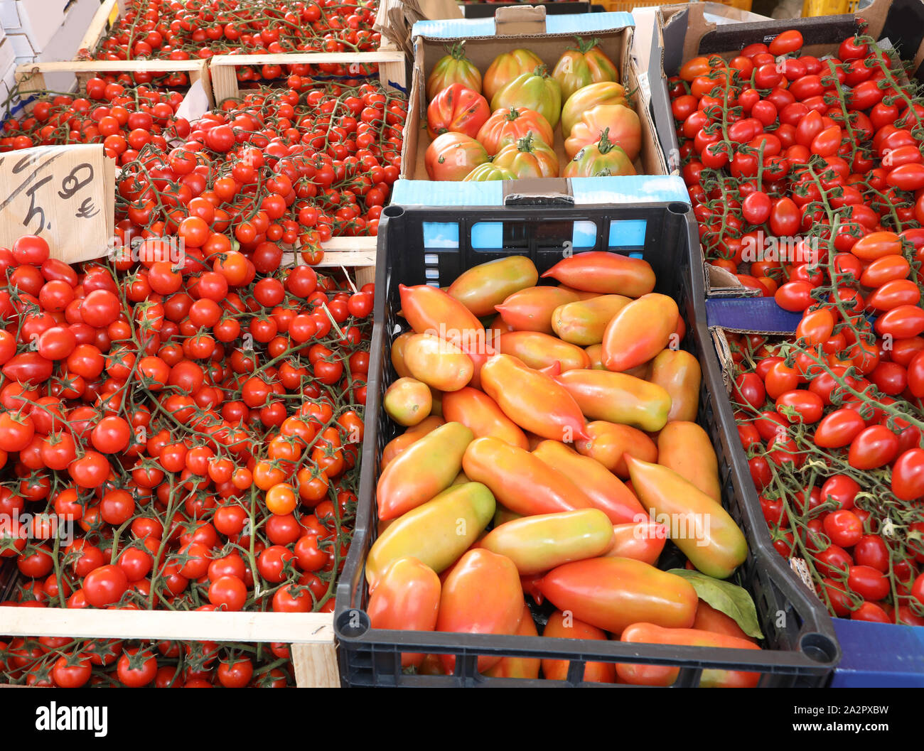 boxes of red tomatoes for sale at market in summer Stock Photo Alamy
