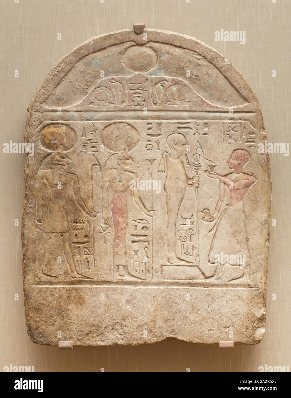 Egyptian, Funerary Stele for Pa-Amun before the Gods, Ptah, Bast and Amun, c. 800 BC, Limestone with traces of polychromy, gold, and terracotta, 22 3/4 x 18 1/8 x 2 3/4 in Stock Photo
