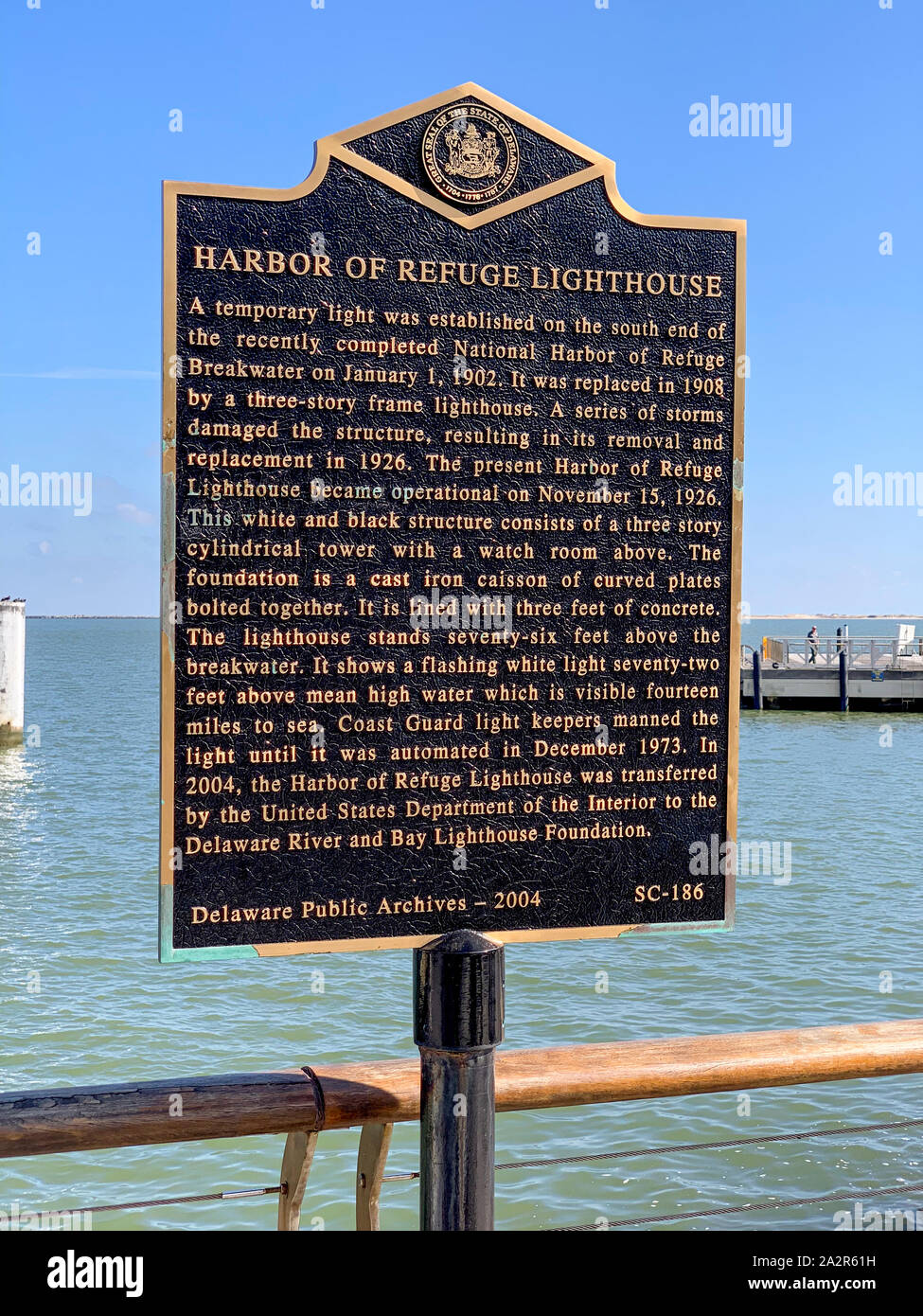 Lewes, Delaware - September 27, 2019 - Harbor of Refuge Lighthouse historical marker on Delaware Bay waterfront. Stock Photo