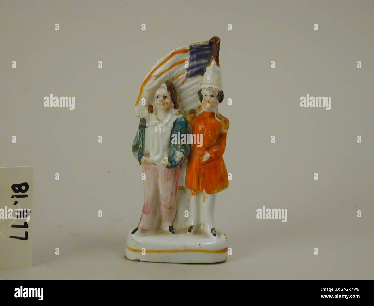 Unknown (English), Two American Soldiers with American Flag, c. 1860, Glazed and enameled earthenware, 4 1/4 x 2 x 1 1/4 in. (10.8 x 5.08 x 3.2 cm Stock Photo