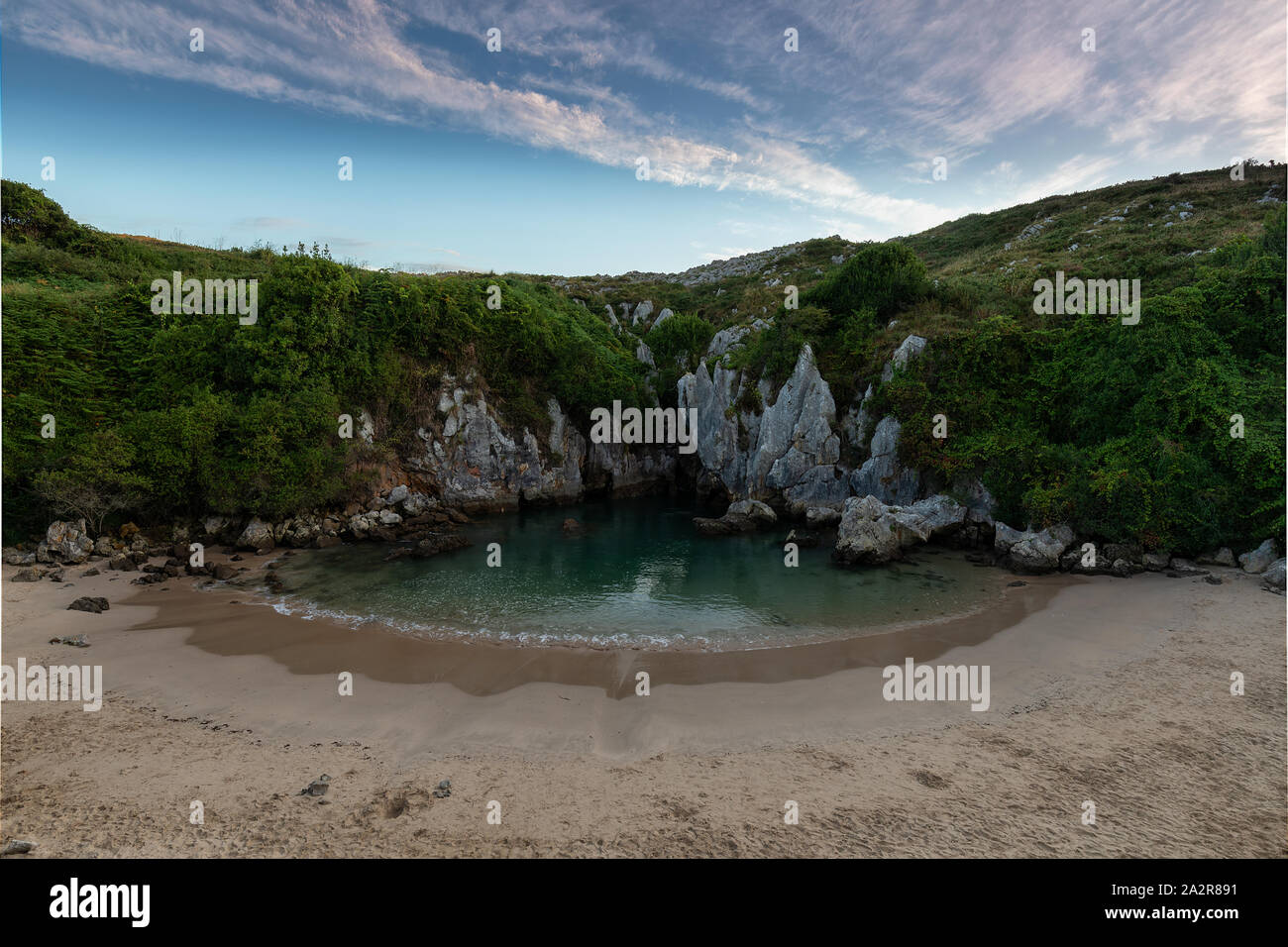 Secret and hidden Gulpiyuri beach in LLanes Asturias Stock Photo