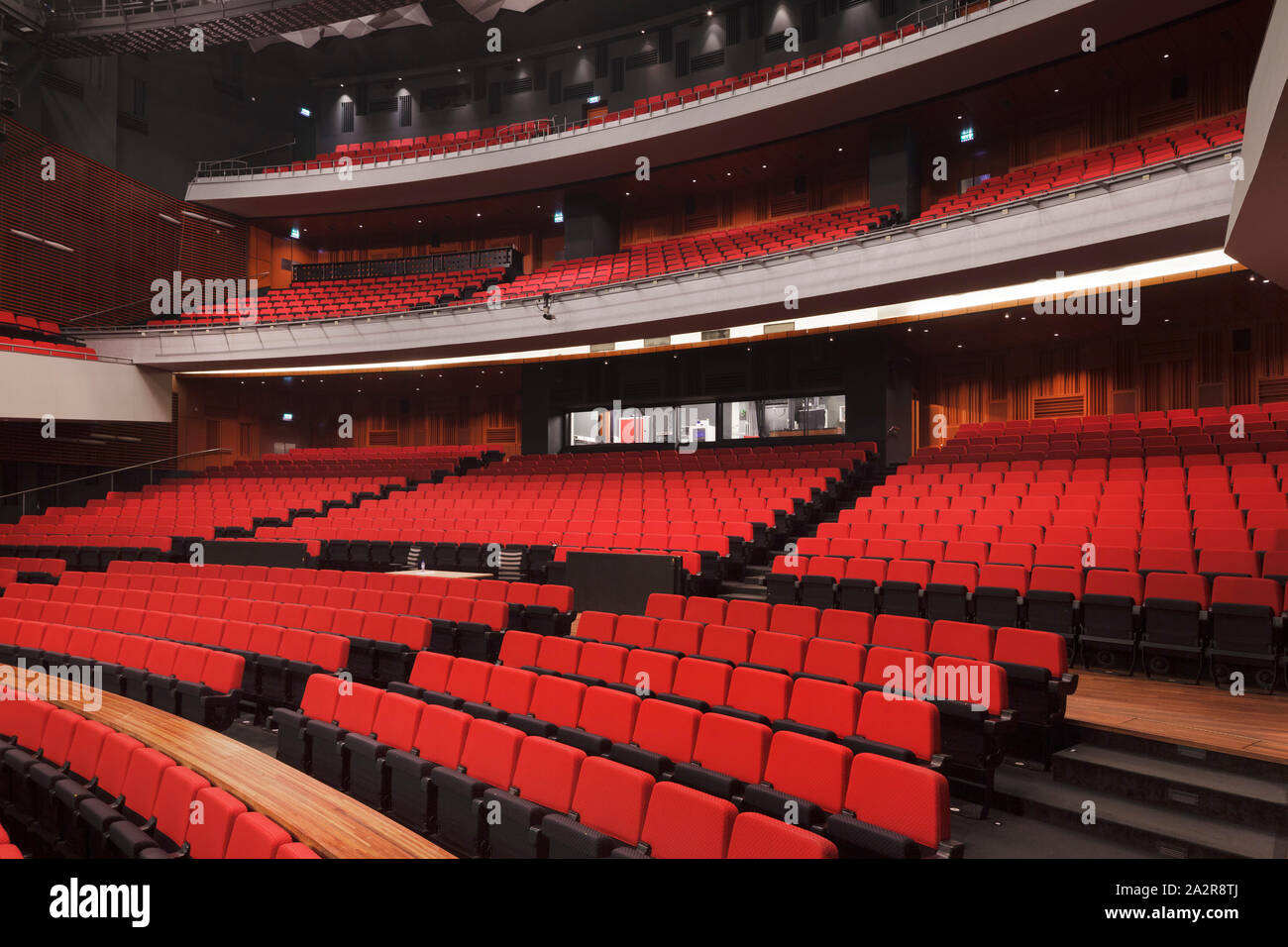 Upper level of auditorium, with red seating. Nieuwe Luxor Theater (New Luxor Theatre), Rotterdam, Netherlands. Architect: Bolles + Wilson, 2001. Stock Photo