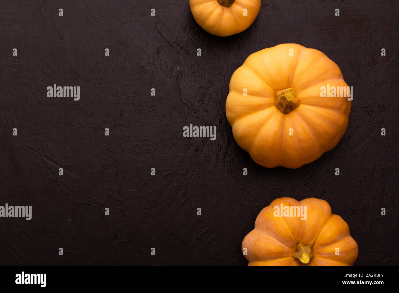 Pumpkins on black table. Halloween background with pumpkin. Copy space ...