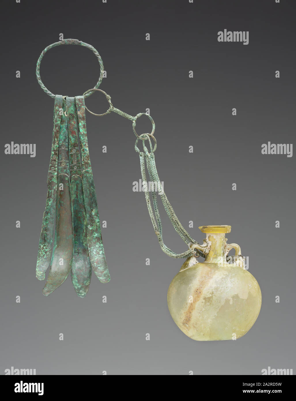 Roman, Oil Bottle with Bronze Chain attached to Ring with Strigils, between 1st and 2nd century CE, glass and bronze, various dimensions Stock Photo
