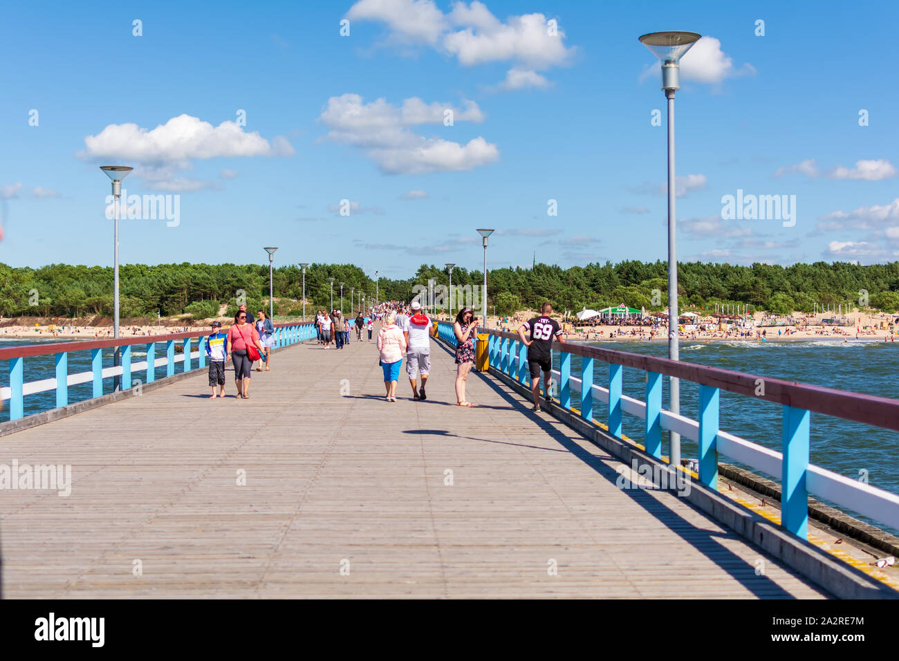 People walking down the Palanga sea pier enjoying the sunny weather. It