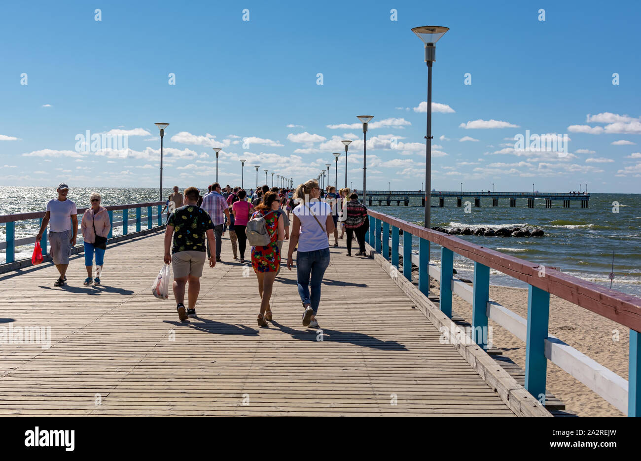 People walking down the Palanga sea pier enjoying the sunny weather. It
