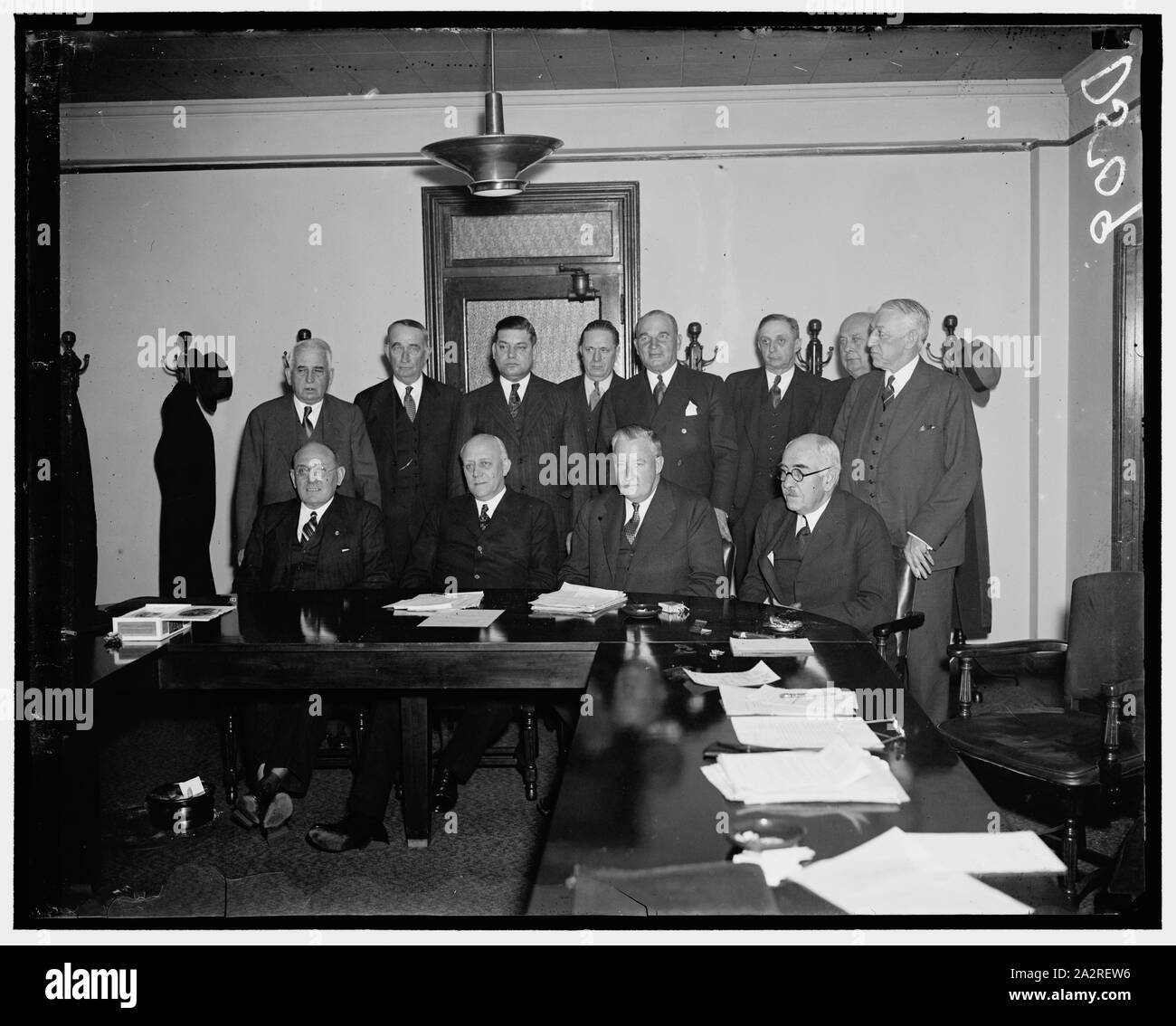 Railway Labor and Capital meet. Washington, D.C., Jan. 7. In compliance with a suggestion made by President Roosevelt in December, a joint conference between committees representing railway labor and railway managements was held here today. The most important matter considered was the Railroad Retirement Act situation, but no conclusion was reached. In the photograph, left to right: (seated) J.A. Phillips, Order of Railways Conductors; M.W. Clement, President of the Pennsylvania Railroad; and George B. Elliot, President of the Atlantic Coast Line; standing, left to right: E.J. Manion, Order of Stock Photo