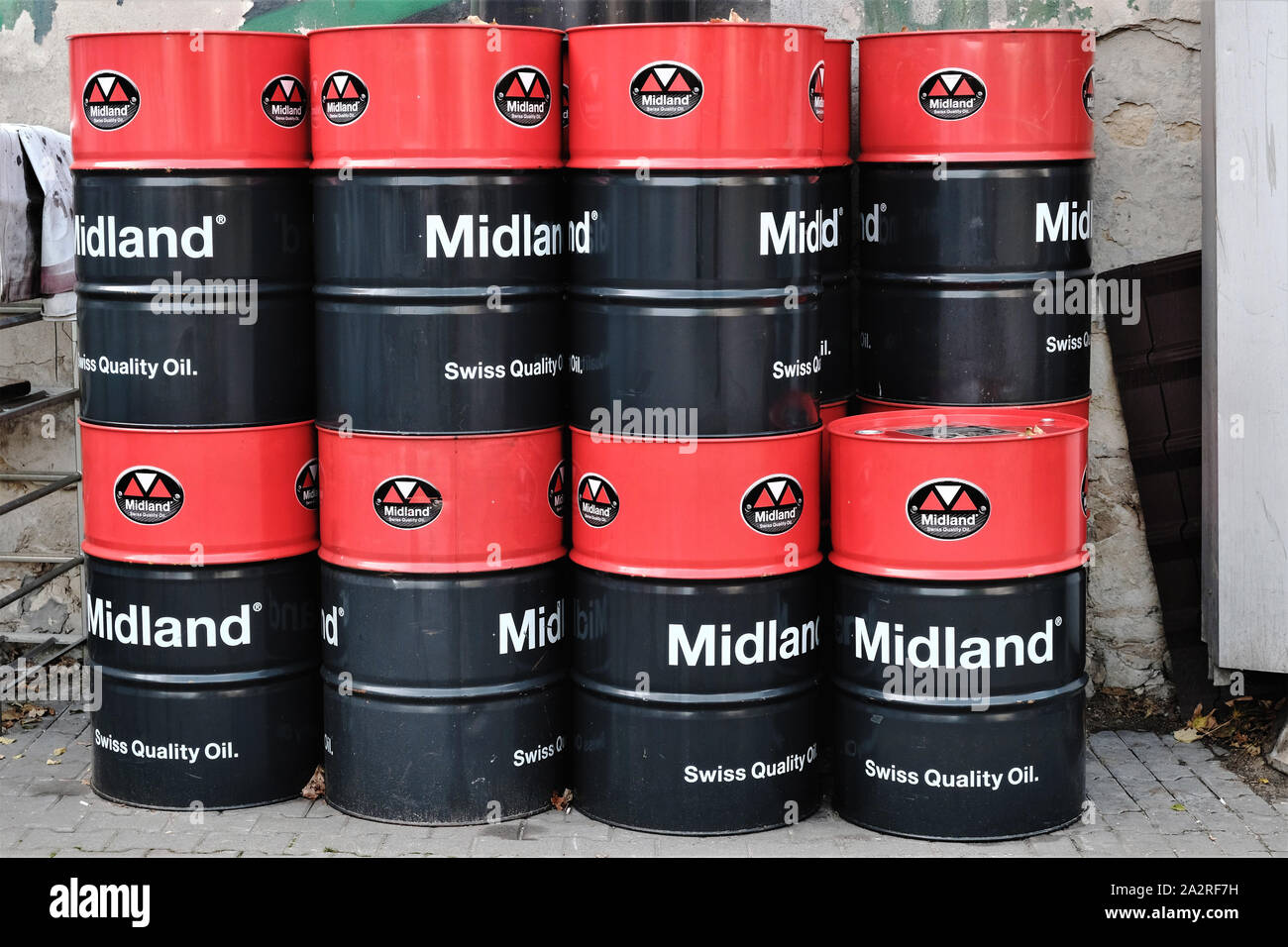 barrels of "Midland Swiss Quality Oil"engine lubricant stacked in the