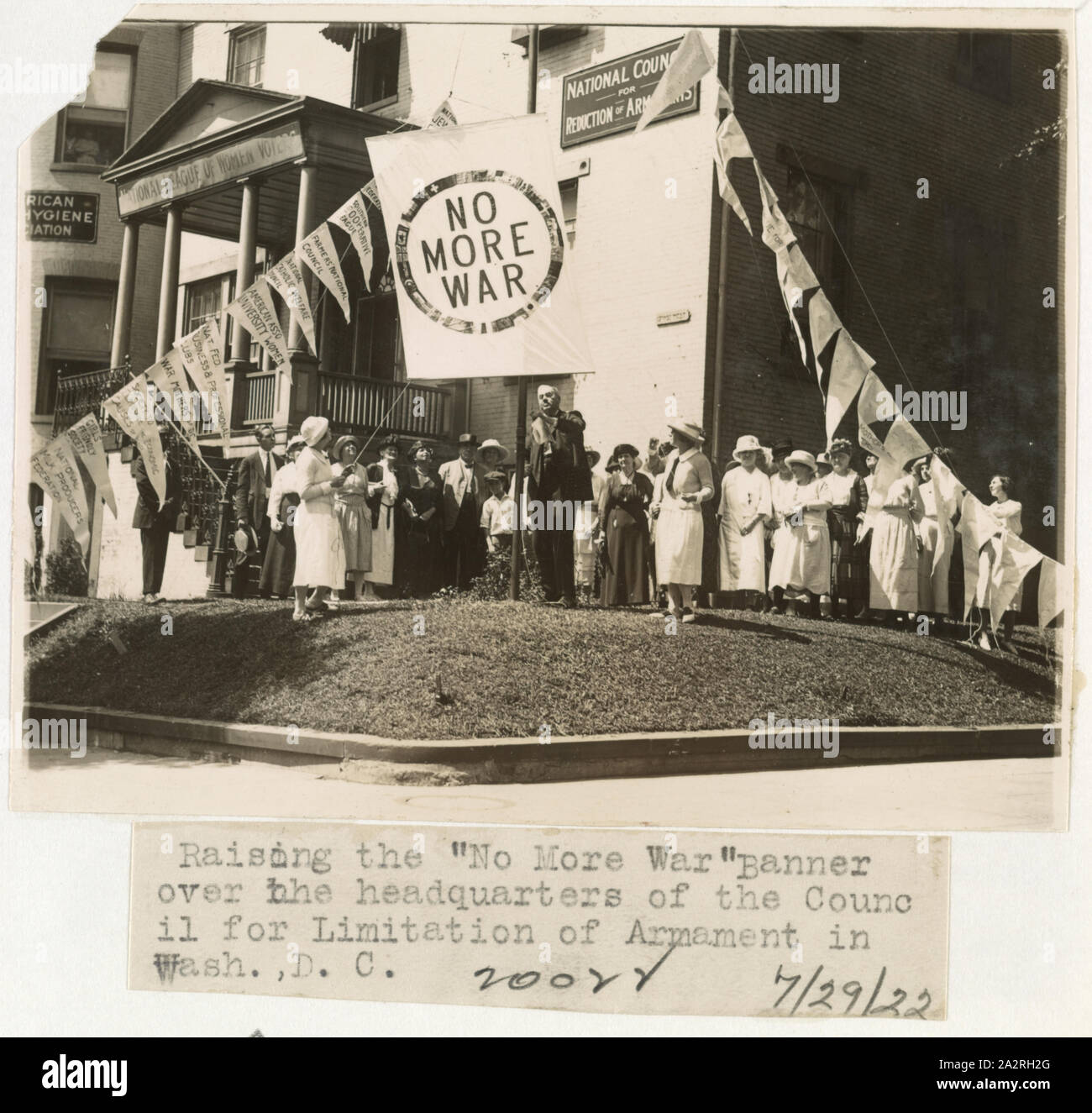 Raising the No more war banner over the headquarters of the Council for Limitation of Armaments in Wash., D.C. Stock Photo