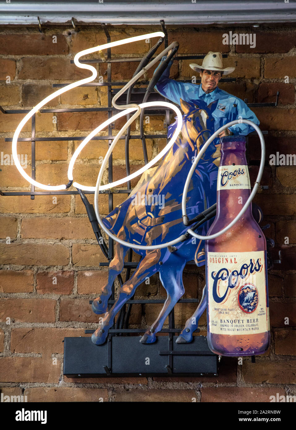Rambunctious neon beer sign inside the Springs Downtown Bar and Grill