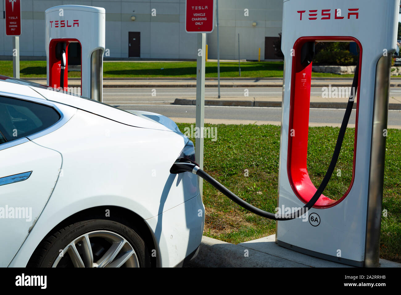 An electric Tesla car charging in Ontario Canada Stock Photo Alamy