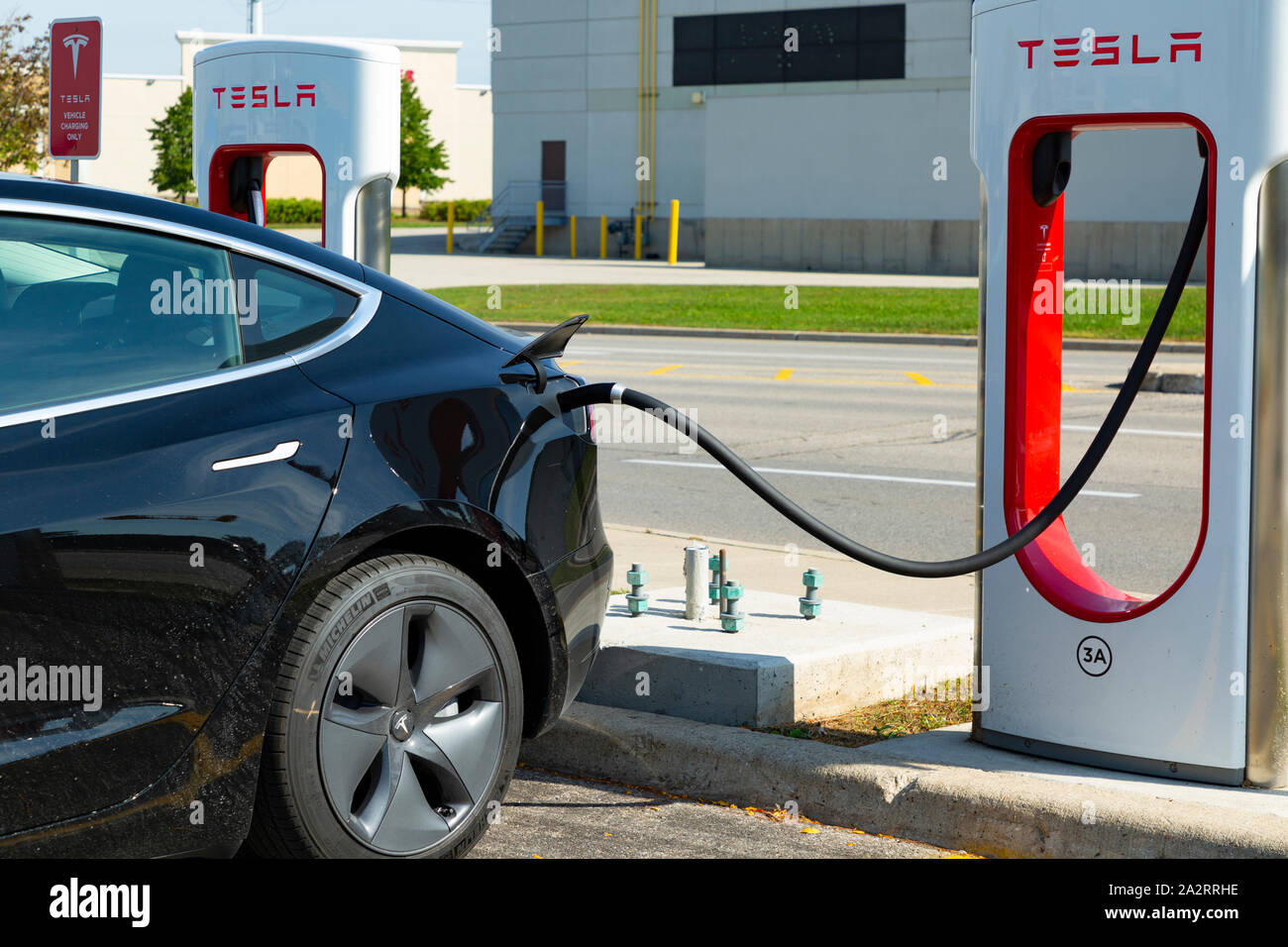 An electric Tesla car charging in Ontario Canada Stock Photo Alamy