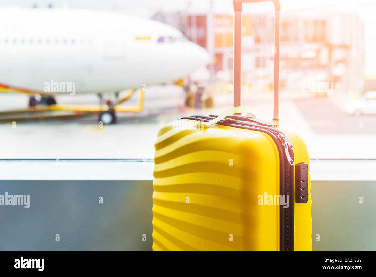 The bright and stylish cabin size suitcase in the airport, holiday