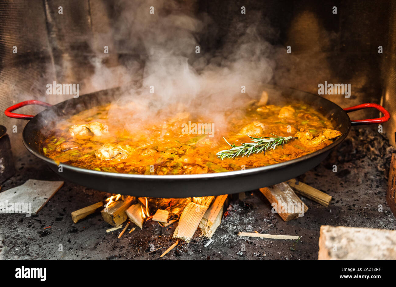 Cooking and making a traditional Spanish Paella over open fire