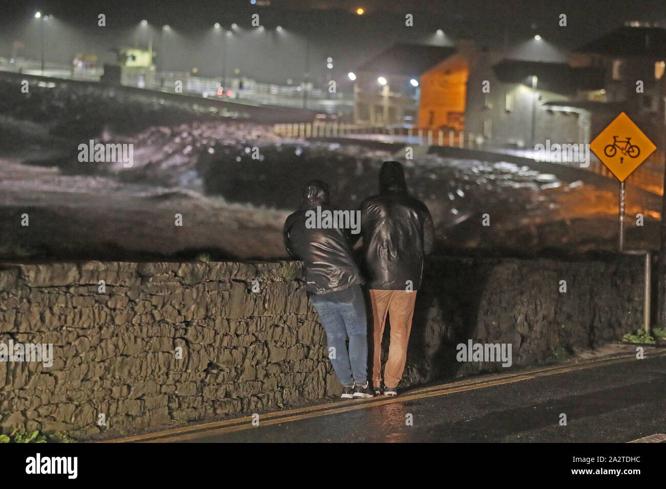 People watch the sea in Lahinch, County Clare, on the West Coast of Ireland as storm Lorenzo makes landfall, with a status orange wind warning and a yellow rain warning having been issued. Stock Photo