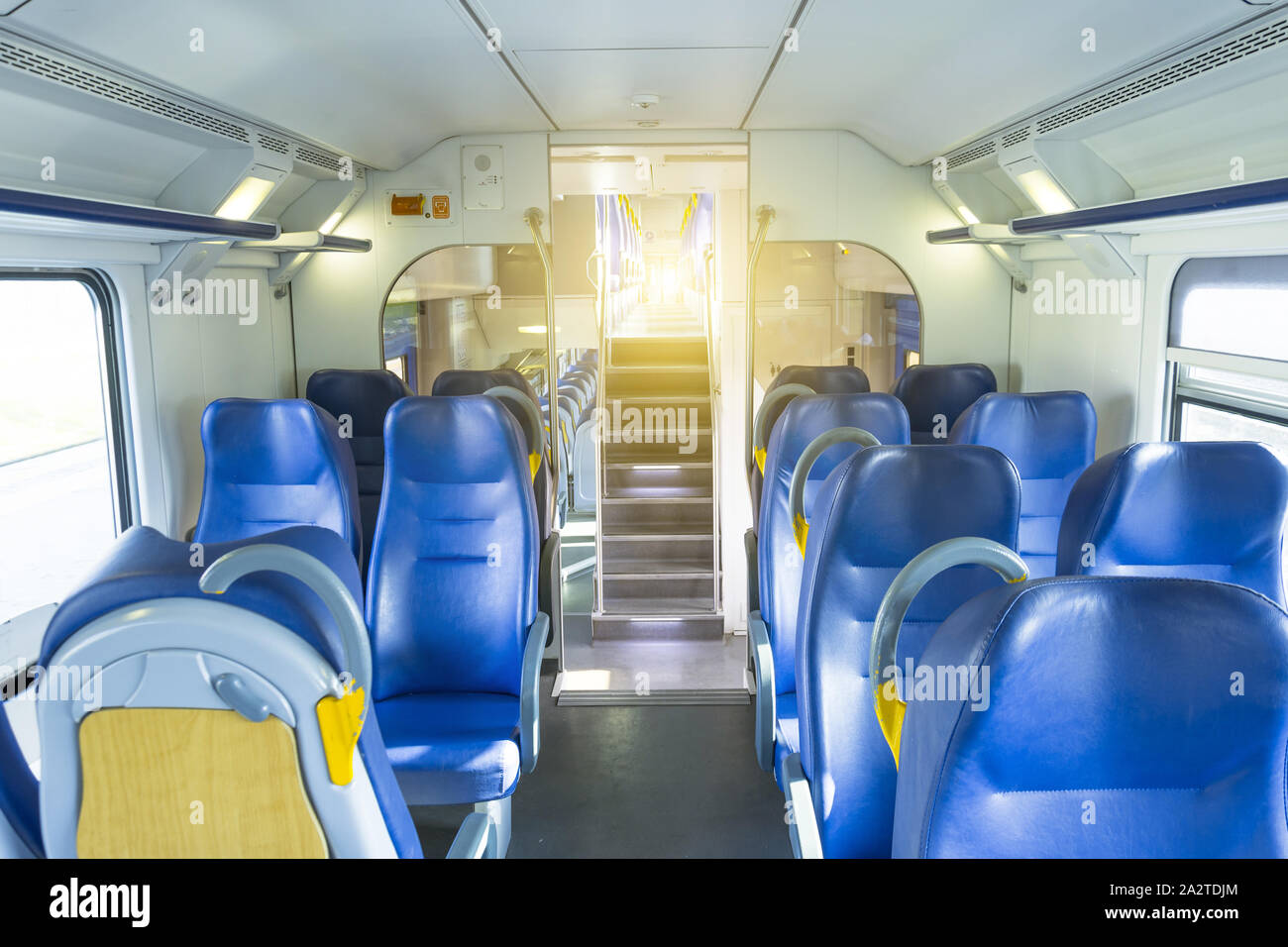 Salon inside of the speed commuter train with empty seats staircase to the second floor Stock Photo