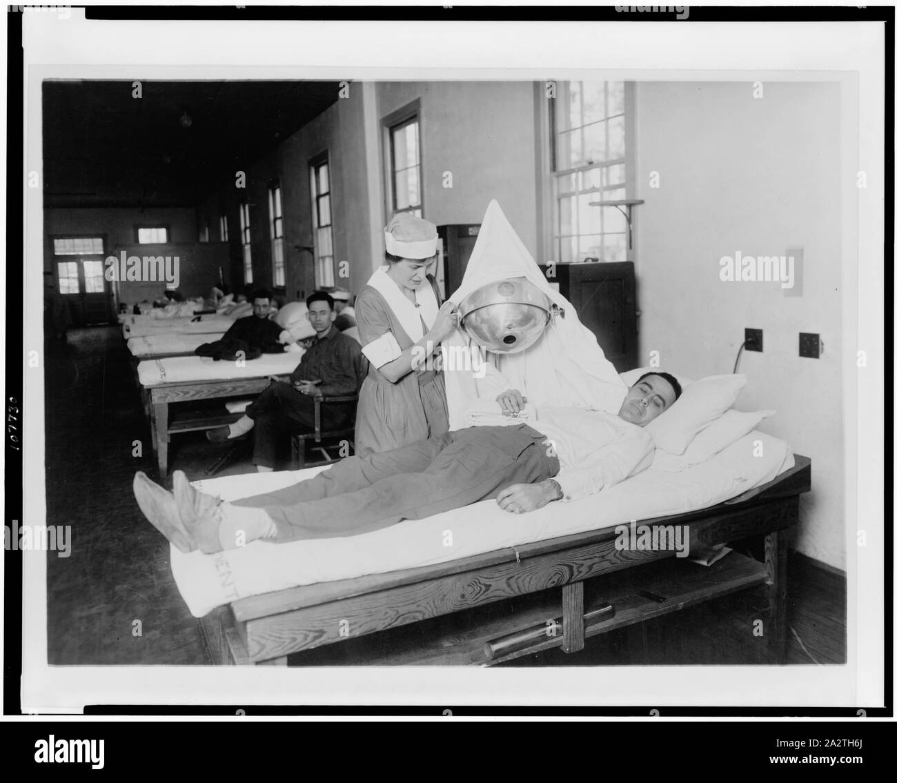 Red Cross nurse giving physiotherapy to soldier in Walter Reed Hospital ...