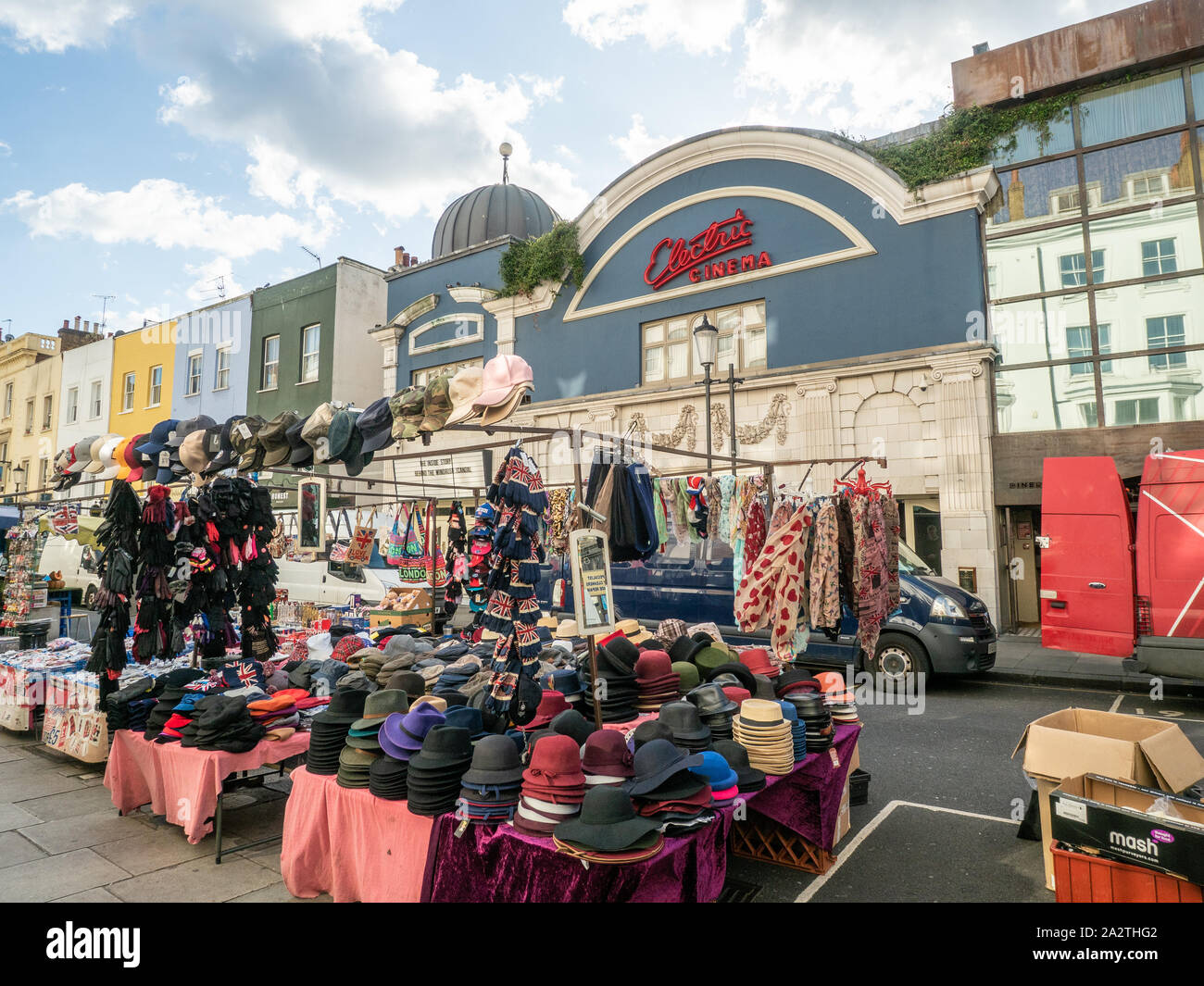 Hats for sale at a market on Portabello road, Notting Hill, London.Behind is the blue facade of Electric Cinema. Stock Photo