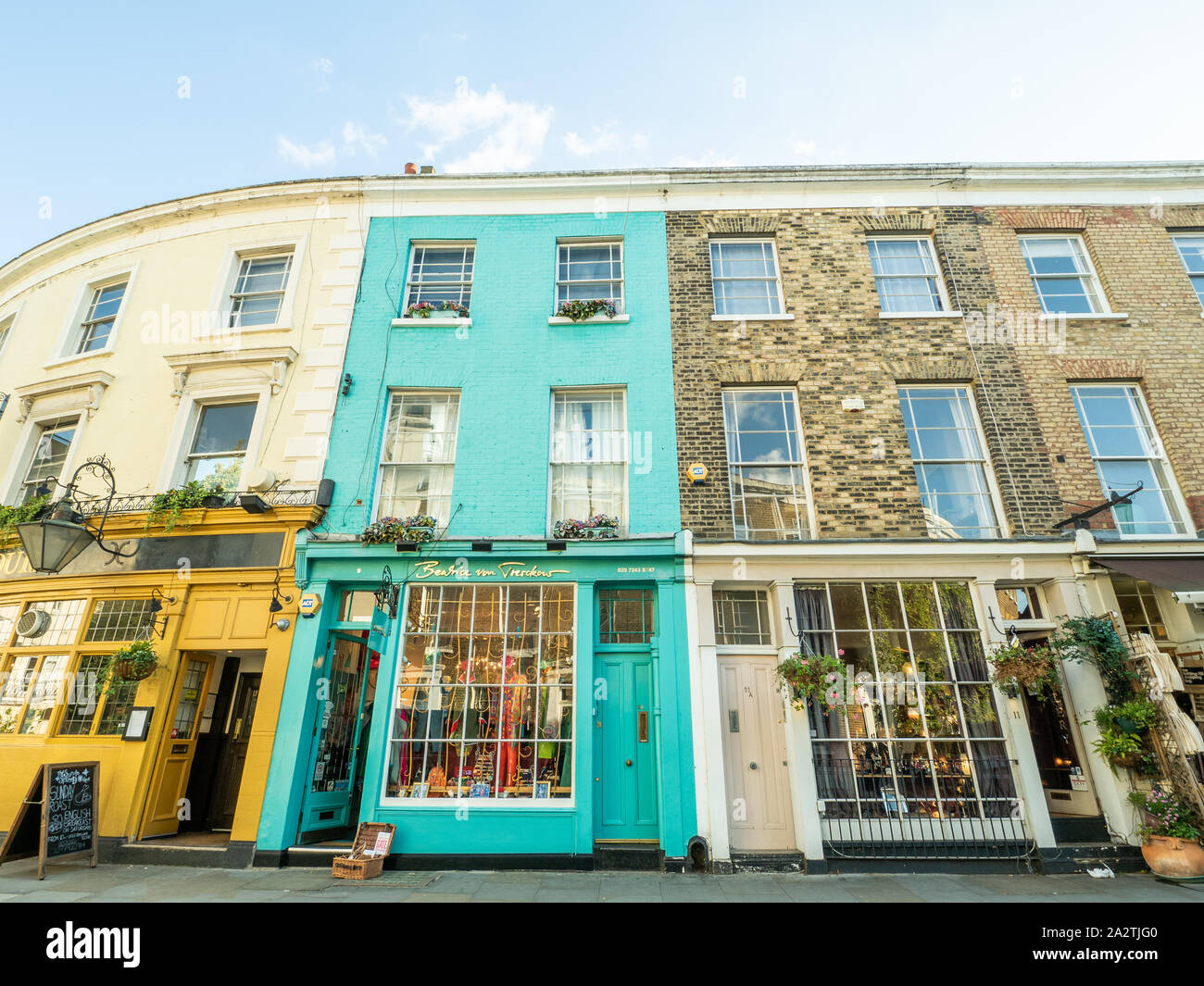 Quaint and colourful shops on Portabello road, Notting Hill, London. Sun in Splendour pub on the left. Stock Photo