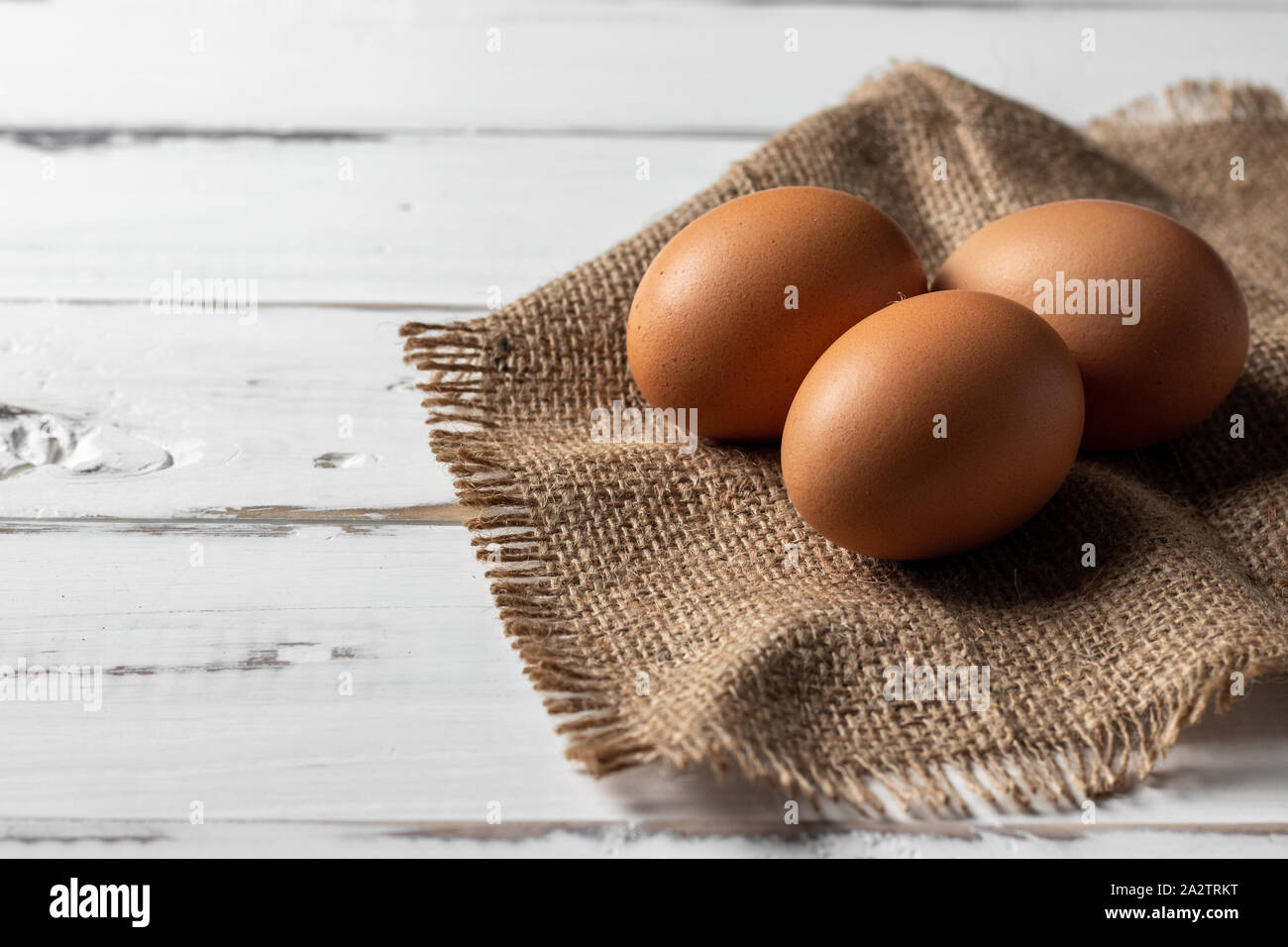 Fresh farm brown chicken eggs over a rustic background Stock Photo - Alamy