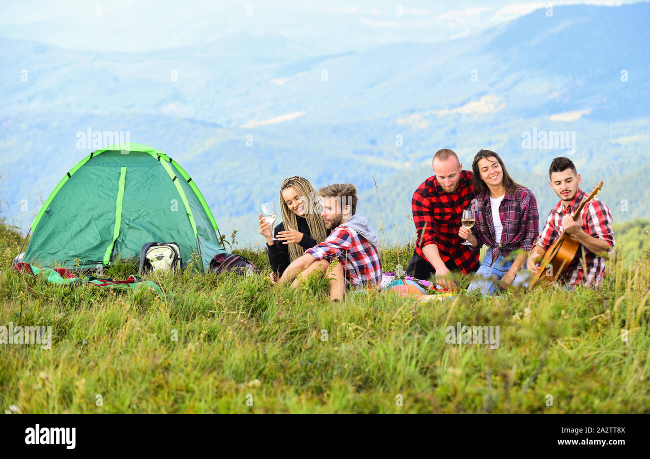 Enjoying warm day. friends camping. reach destination place. men and women  on picnic at tent. wanderlust discovery. mountain tourism camp. group of  people spend free time together. hiking outdoor Stock Photo -
