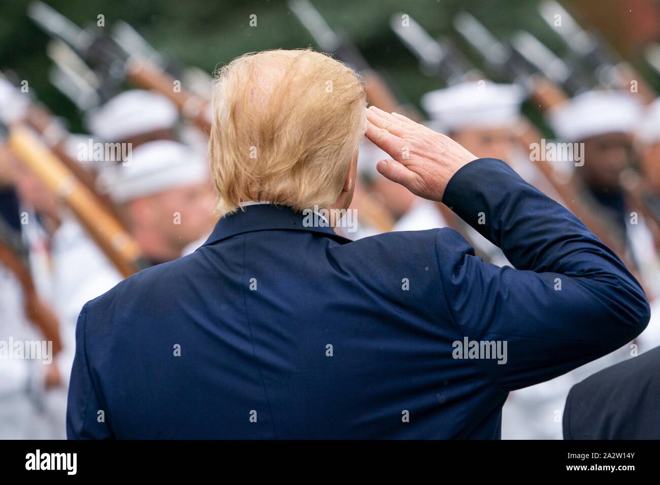 U.S President Donald Trump salutes during a review of troops at a ceremony marking the retirement of outgoing Chairman of the Joint Chiefs Gen. Joseph Dunford and the elevation of incoming Chairman Gen. Mark Milley at Summerall Field, Joint Base Myer-Henderson Hall September 30, 2019 in Arlington, Virginia. Stock Photo