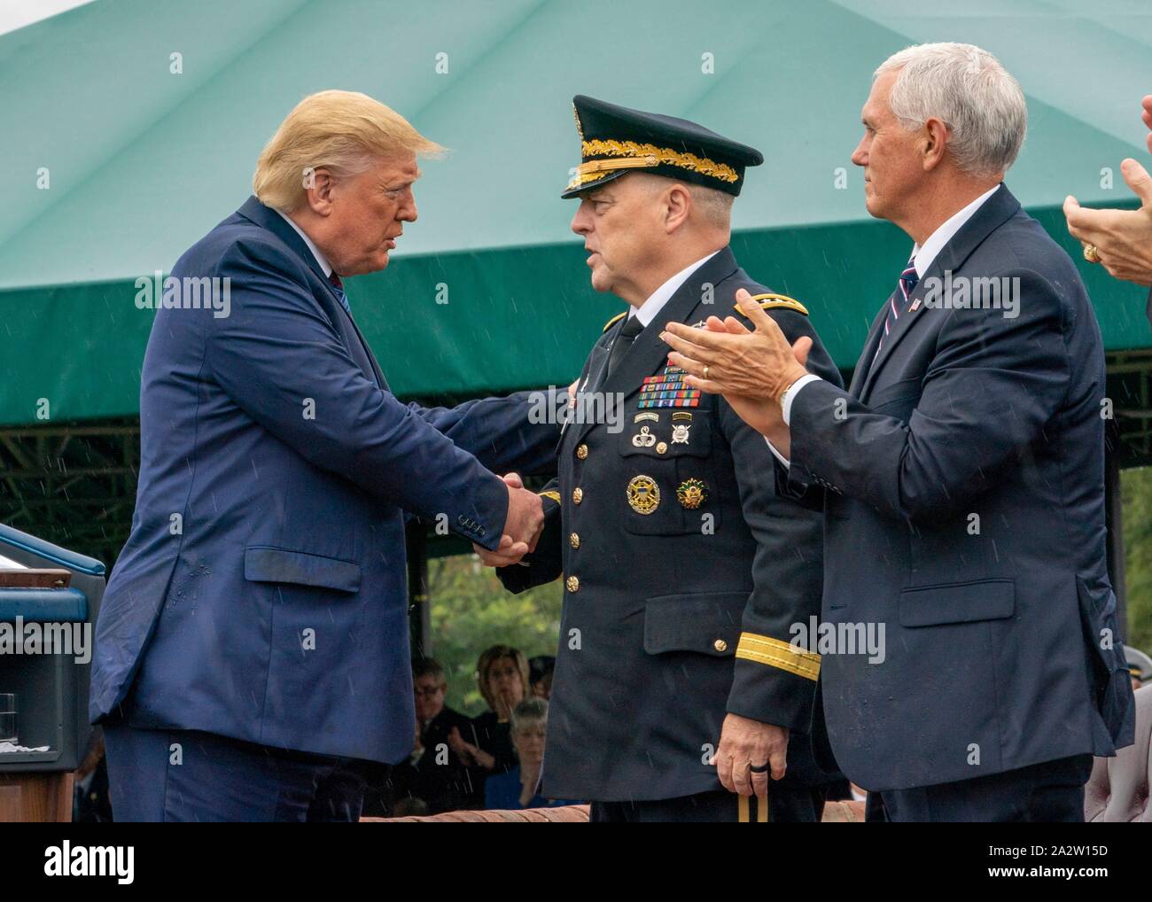 U.S President Donald Trump, left, congratulates incoming Chairman Gen. Mark Milley, center, as Vice President Mike Pence looks on, during a ceremony marking the retirement of outgoing Chairman of the Joint Chiefs Gen. Joseph Dunford and the elevation of Milley at Summerall Field, Joint Base Myer-Henderson Hall September 30, 2019 in Arlington, Virginia. Stock Photo