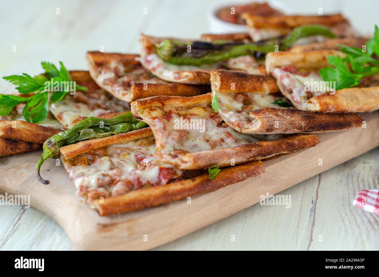 Traditional Turkish cuisine : Pita(pide) with minced meat and cheese, close up. Stock Photo