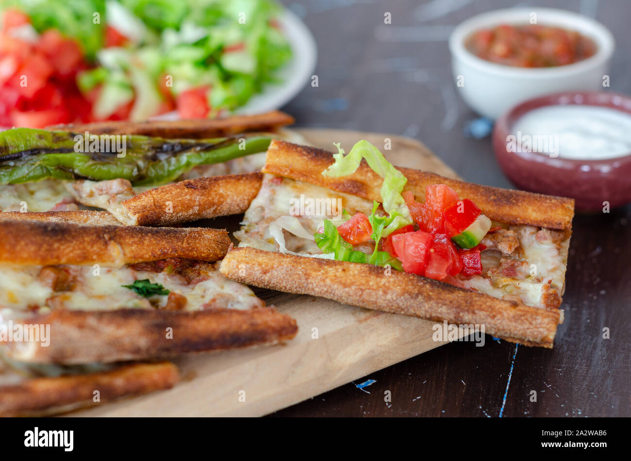 Traditional Turkish cuisine : Pita(pide) with minced meat and cheese, close up. Stock Photo