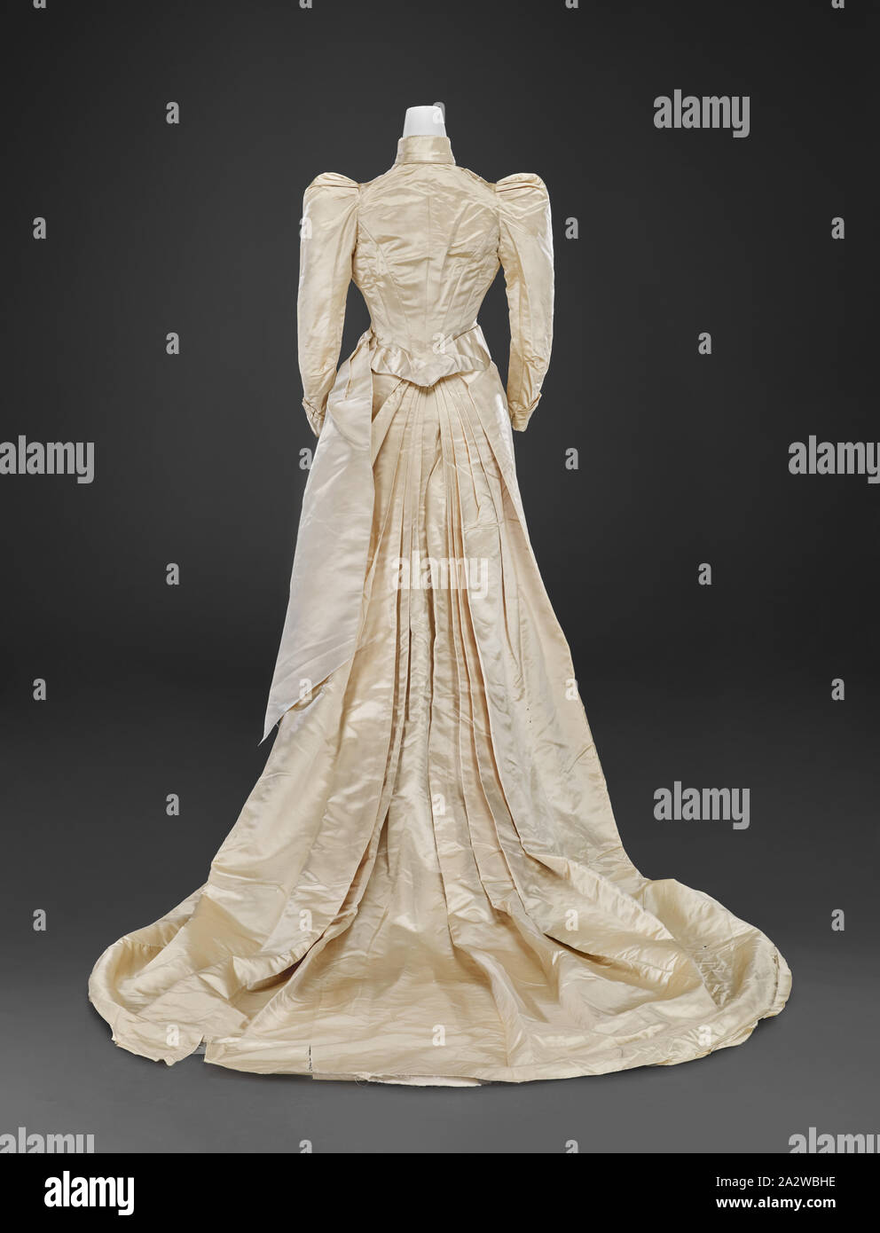wedding gown (bodice, skirt, train), Louis Valentin, Dressmaker (American, born Hungarian, about 1859-1937), 1890, silk, lace, A) bodice: center back 17 in., center front 15 in., bust 30-1/2 in., waist 23-1/2 in., sleeve length 19 in., shoulders 11 in. B) skirt: center back 38-1/2 in., center front 38-1/2 in., waist 19 in., hips 40 in. C) train: 70 x 50 in. D) fabric fragment: 110 x 11-1/4 in. E) fabric fragment: 23-1/2 x 14 in., A) bodice: Label, sewn: Louis Valentin, Boston Label, handwritten and sewn: Mary Addison Bybee, October 15 1890, Indianapolis Indiana, Textile and Fashion Arts Stock Photo