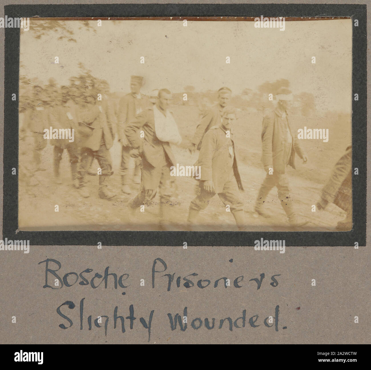 Photograph - 'Bosche Prisoners, Slightly Wounded', France, Sergeant John Lord, World War I, 1916-1917, Photograph which shows a group of slightly wounded German prisoners walking along a road. The caption underneath the photograph describes the soldiers as 'Bosche Prisoners'. The word Bosche was used as a colloquial term for German soldiers during World War I and World War II. The word is derived from the French phrase 'tete de boche' which during World War I was taken to mean 'hard headed Stock Photo