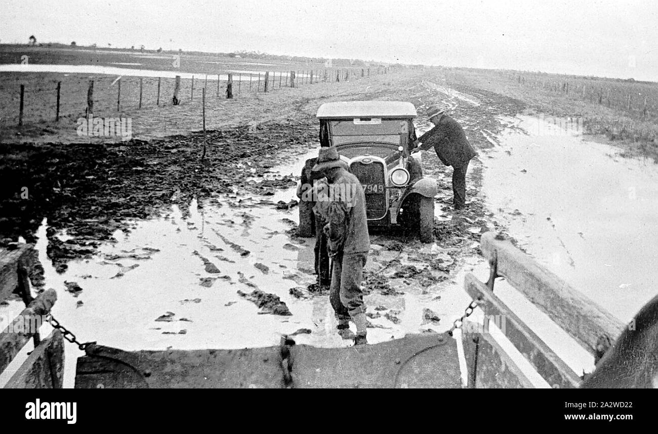 Negative - Chains Being Attached to Car To Be Pulled Out of Mud, Laen East, via Donald, Victoria, 1931, Chains being attached to car to be pulled out of mud Stock Photo