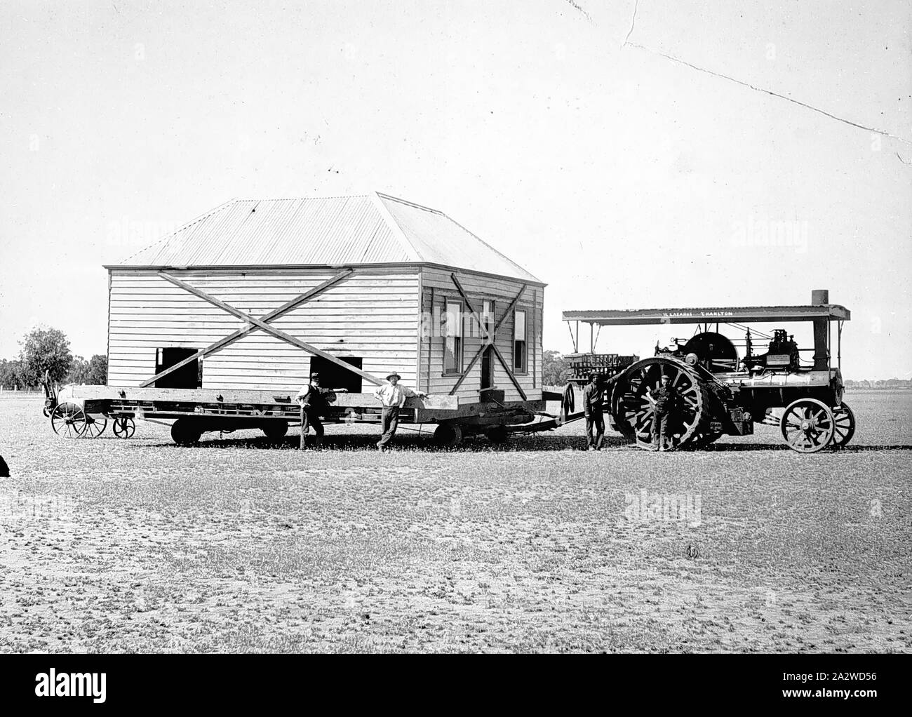 Negative - Charlton, Victoria, 1909, A house being moved using a Foden traction engine. The house is braced with diagonal struts Stock Photo