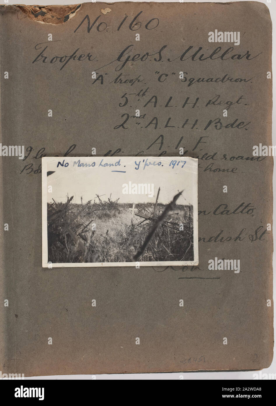 Photograph - Grave in 'No Mans Land', Ypres, Belgium, Trooper George Simpson Millar, World War I, 1917, Album page with photograph. The album belonged to George Simpson Millar, an Australian serviceman in the 5th Australian Light House during World War I. The album contains 103 small black and white photographs, mainly of Gallipoli in 1915 and some of France and Belgium. They are believed to have been taken by Trooper George Simpson Millar, service no. 160, 'A' Troop, 'C' Squadron, 5th Australian Stock Photo