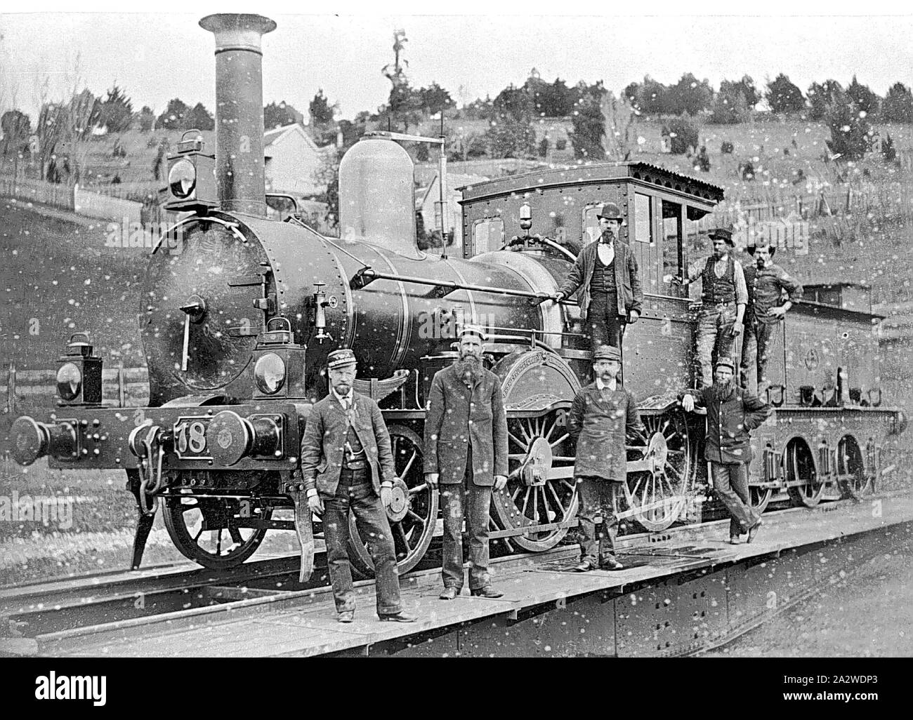Negative - Victorian Railways F-class 2-4-0 Steam Locomotive & Crew on the Turntable, Daylesford, Victoria, 1890, Copy of a black & white photograph depicting one of the 2-4-0 type steam passenger locomotives built by the Phoenix Foundry, of Ballarat, during the late 1870s, for use on the country branch lines or 'light lines' that were built throughout central Victoria between 1873 and 1893. The engines were built in two batches Nos.126-144 (even numbers only), which went into service in 1876-77 Stock Photo