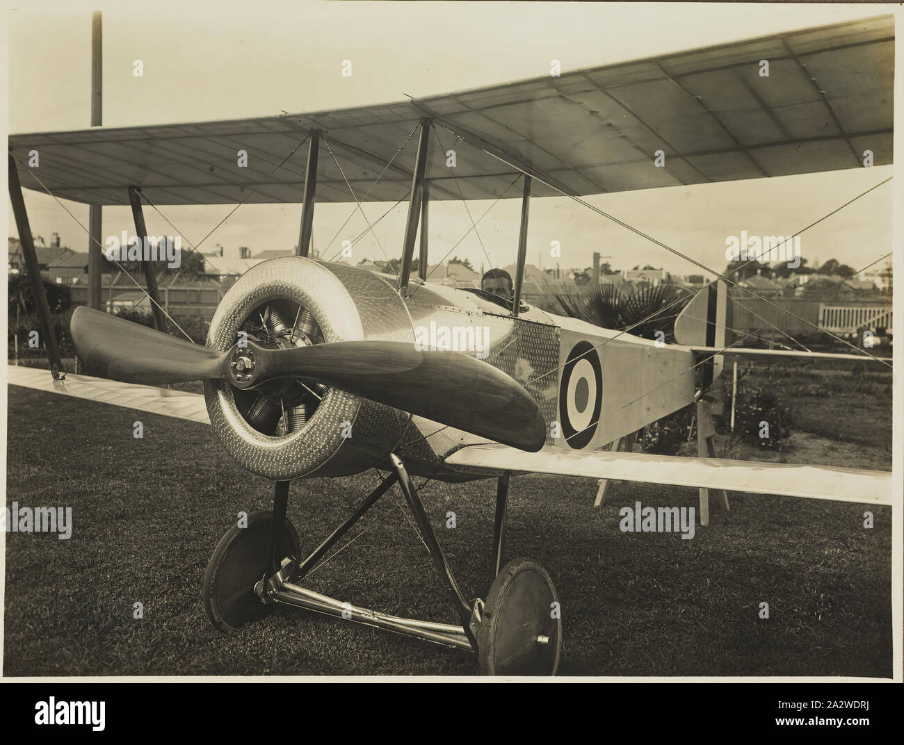 Photograph - Basil Watson Seated in his Completed Biplane Outside the Family Home, 'Foilacleugh', Elsternwick, Victoria, 1916, Part of a commemorative photograph album produced by Sears' Studios, Melbourne, documenting the work of Basil Watson in constructing a biplane at his family's home 'Foilacleugh' in Elsternwick, Victoria, during 1916, and the aftermath of his fatal crash off Point Cook on 28th March 1917. The biplane was based on the design of the Sopwith Pup Stock Photo