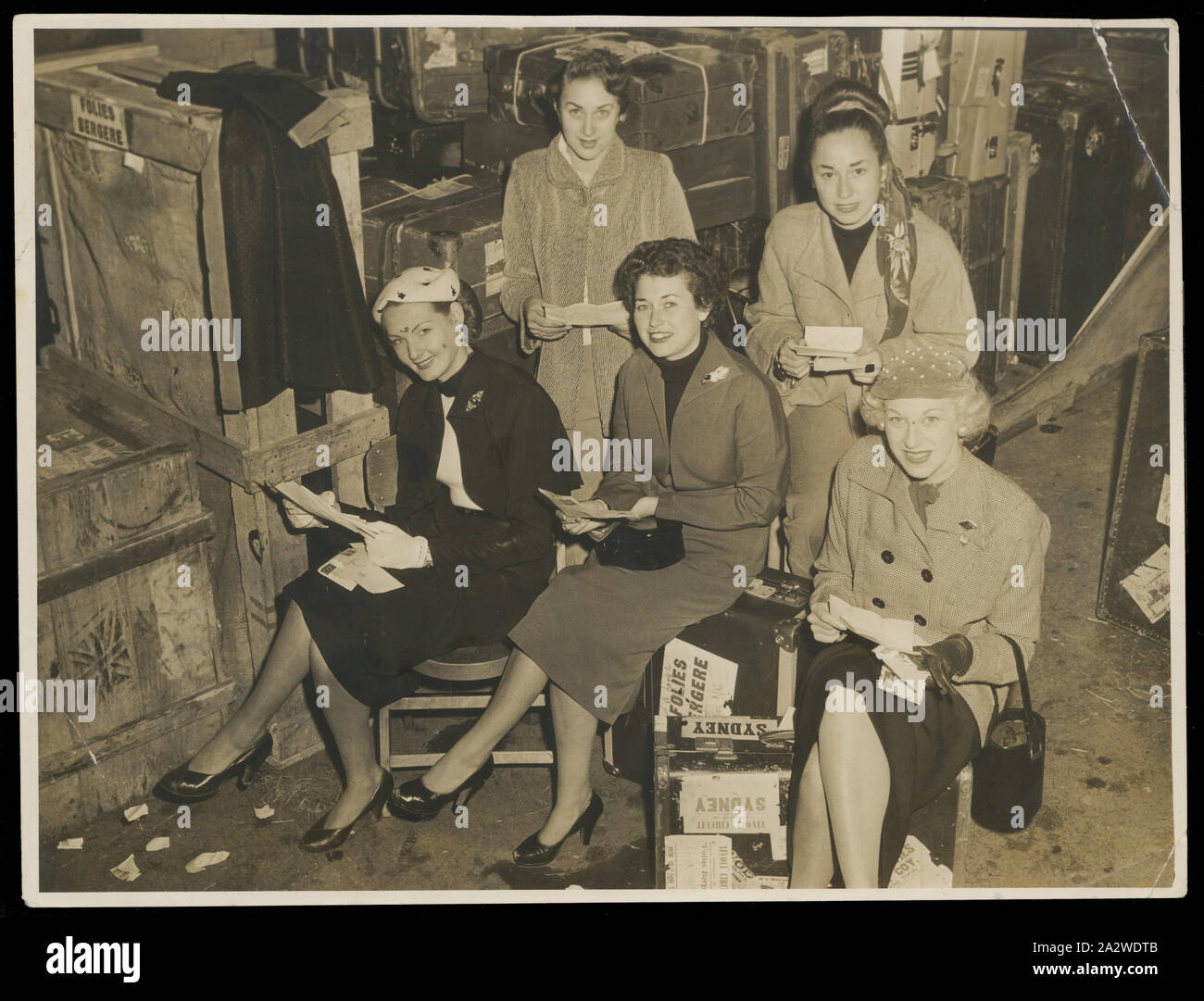 Photograph - Bernice Kopple and four Folies Bergere Dancers, Australia, 1950s, Photograph of Bernice Kopple (centre) and four other dancers of the Folies Bergere Show on the Tivoli Circuit tour in Australia,1950s, in street clothes seated among suitcases, probably backstage before going to Sydney. In the 1950s and 1960s Bernice Kopple worked as a fashion photographic model and as a performer on the Tivoli Circuit. Bernice Kopple was born in Glasgow, Scotland in 1930 Stock Photo