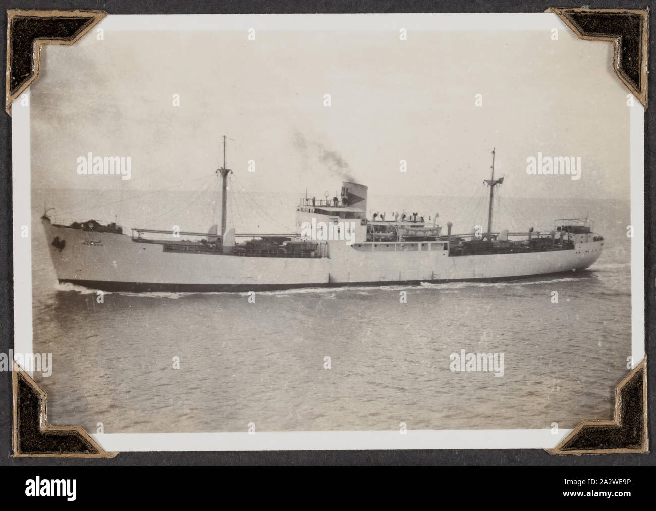 Photograph - Cargo Ship, Palmer Family Migrant Voyage, North African Coast, 02 Mar 1947, Black and white photograph titled 'Cargo Boat', it shows a ship, taken 2 March 1947. It is part of a leather-bound photo album created by George Palmer during his migrant voyage from England to Australia on the RMS Orion in 1947. George migrated to Australia with his wife Gertrude and their two daughters, Shirley and Lesley. the album record the Palmers' life in England, their Stock Photo