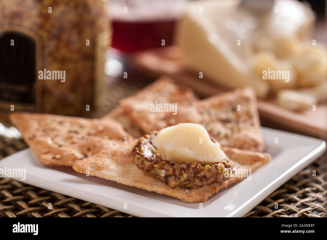 Fontal Cheese with Mustard on Crackers Stock Photo