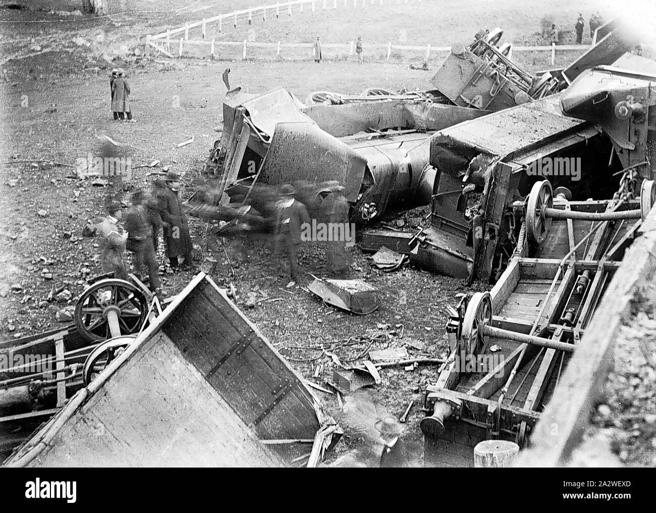 Negative - Kurkuruc Creek, Victoria, Oct 1907, An elevated view of the damaged locomotive and goods trucks which derailed whilst crossing a bridge at Kurkuruc Creek, 4 October 1907. The photo is taken from the bridge itself, and shows several groups of men inspecting the derailed train. Both the engine driver, Joseph Duke, and the fireman, Edwin Cherry, were killed in the accident. The 4-6-0 steam goods locomotive No.614 was hauling the train Stock Photo