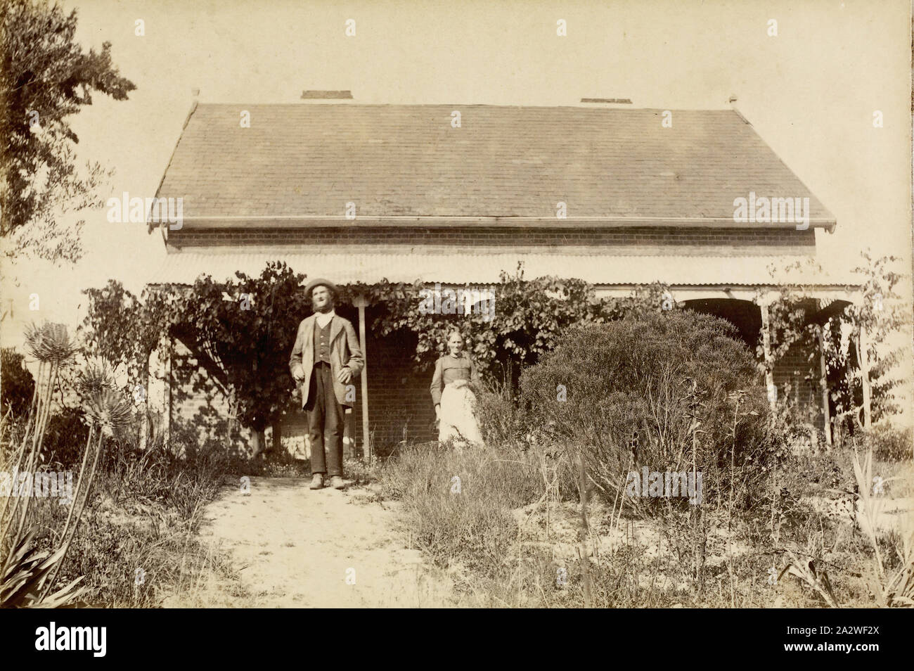 Digital Photograph - Charles & Ellen Partington Outside 'Willis Vale' Homestead, Greensborough, Victoria, circa 1885, Charles Partington (senior) and his wife Ellen (nee Whatmough), standing in front of the old 'Willis Vale' homestead, at Greensborough. The house was built in 1839 of hand-made bricks, all made and fired on the property Stock Photo